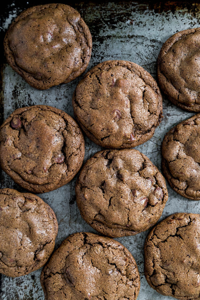 Nine double chocolate cookies sitting on a metal cookie sheet